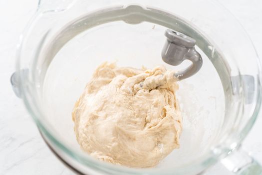 Mixing bread dough in a stand-alone kitchen mixer to bake patriotic cinnamon twists.