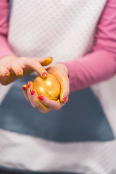 Easter egg coloring. Painting Easter eggs with gold luster.