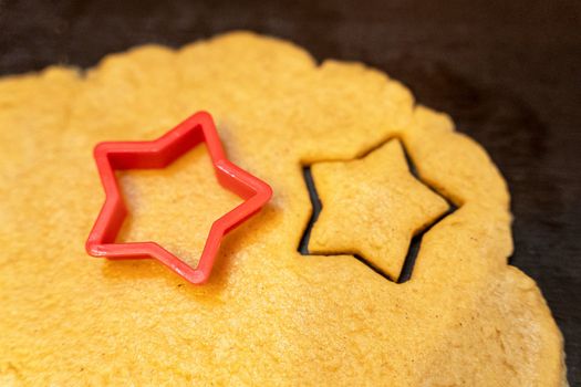 cookie cutter . Dough for preparing cookies. mold for making cookies. cutting the dough with the molding trim.