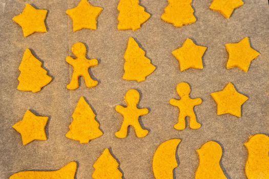 unbaked cookies on a baking sheet from the oven, close-up of various shapes of cookies. figurines, cookies, baking sheet, baking paper. background