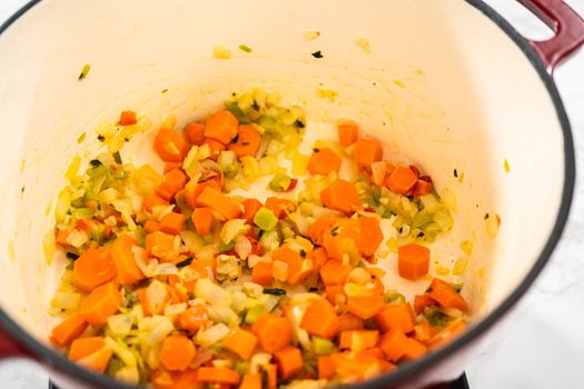 Cooking chicken noodle soup with kluski noodles in an enameled dutch oven.