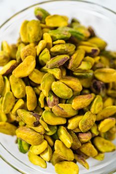 Measured ingredients in glass mixing bowls to make chocolate pistachio fudge.
