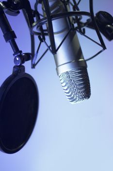 Professional microphone suspended in the air of professional studio