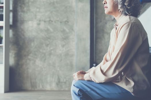 Senior woman feeling blue worried about health problems.