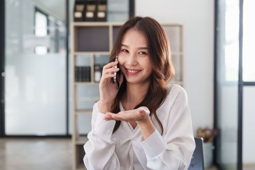 Beautiful asian business woman with smartphone in office. Woman in casual at office.