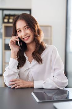 Beautiful asian business woman with smartphone in office. Woman in casual at office.