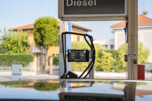 Service gas station with diesel. Close-up of a gas pump fueling gun. Petrol station. Italy