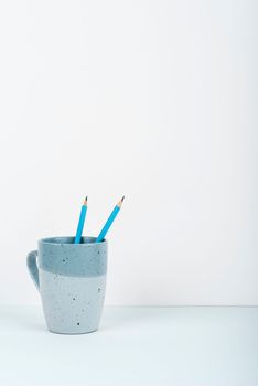 Coffee Cup Standing on Desk. Important infrormation written on paper.