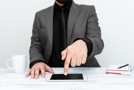 Businessman sitting at a table And Pointing With One Finger On Message