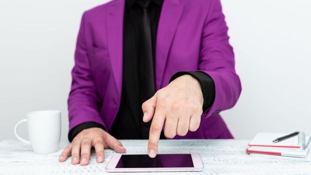 Businessman sitting at a table And Pointing With One Finger On Message