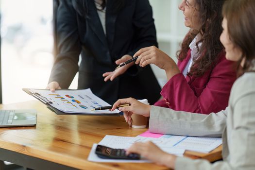 Business People Meeting to discuss and brainstorming the financial report paperwork in home office. Financial advisor teamwork and accounting concept.