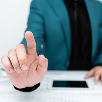 Businessman in a Blue jacket sitting at a table Phone on table.