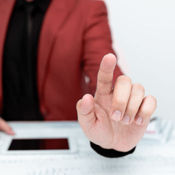 Businessman in a Red jacket sitting at a table Phone on table.