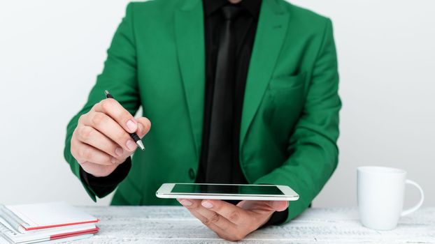 Man in jacket sitting at white table And Pointing With Pen On Message.