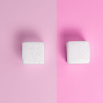 White Styrofoam Cubes Lying on Coloured Desk. Brand new Information.
