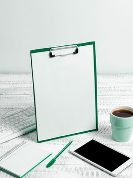 Notebook With Important Messages On Desk With Coffee, Phone And Pen.