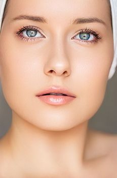 Skin care and beauty routine, beautiful woman with white towel wrapped around head, skincare cosmetics and face cosmetology, close-up portrait