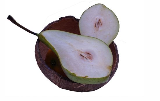 Fresh pear in coconut shell on white background.