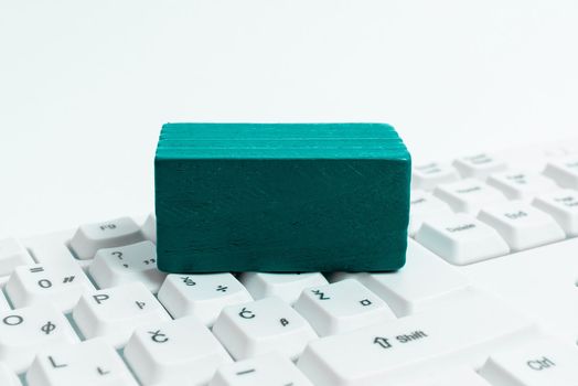 Colored cube with important message lying on keyboard. Main information.