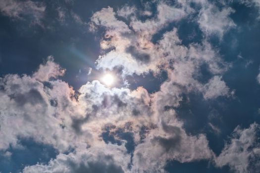 Sunbeam through the haze on blue sky , clouds with sun rays Suitable for making background images.