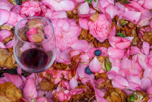 Wine glasses in pink rose garden