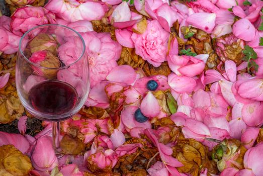Wine glasses in pink rose garden