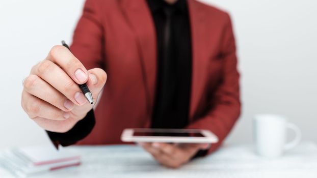 Man in jacket sitting at white table And Pointing With Pen On Message.