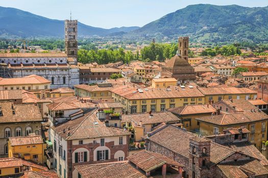 Historical medieval town Lucca with old buildings and mountain range, Tuscany, Italy