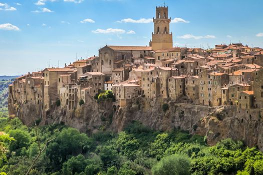 Historical medieval town Pitigliano with old buildings and mountain range, Tuscany, Italy