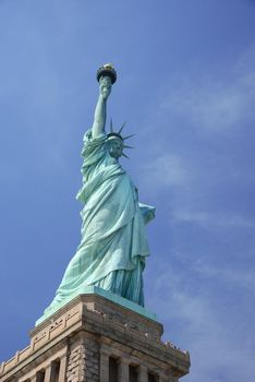 Liberty Statue, a landmark of new york city, with blue sky