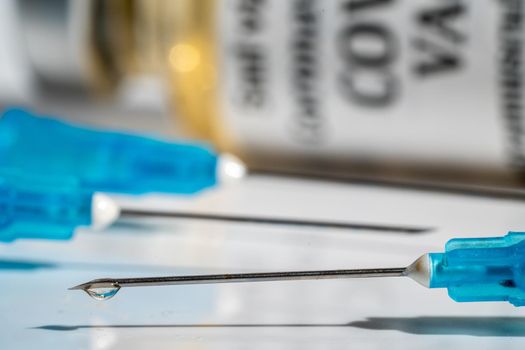 Concept for booster vaccination with three syringes with the third representing the boost for the Covid-19 vaccine