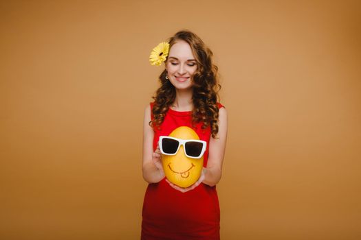 Portrait of a happy young woman holding a melon with glasses. Melon with a smile.