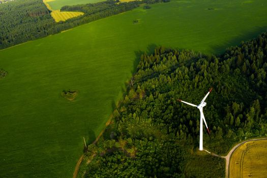 Windmills on the background of forests and fields. Windmill in nature.Belarus.