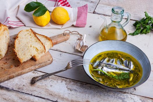 Marinated anchovies in lemon juice with olive oil garlic and parsley. Traditional mediterranean summer food