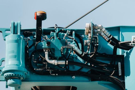 Hydraulic crane engine.The control system of the crane engine.Lifting hydraulic Department on the truck crane.The hydraulic system of the engine.hydraulic hoses on the crane.autoparts.