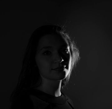 Black and white portrait of an Italian young woman on black background