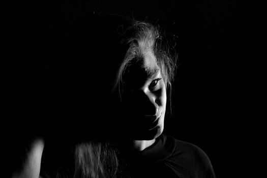 Black and white portrait of an Italian young woman on black background