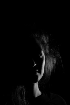 Black and white portrait of an Italian young woman on black background