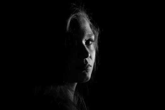 Black and white portrait of an Italian young woman on black background