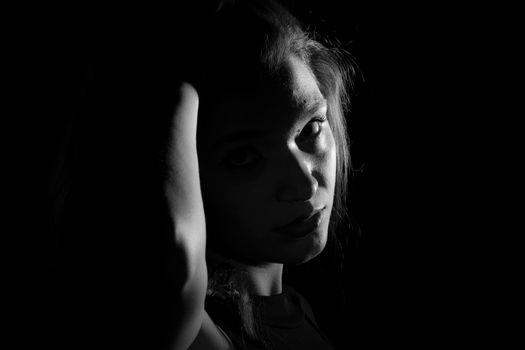 Black and white portrait of an Italian young woman on black background