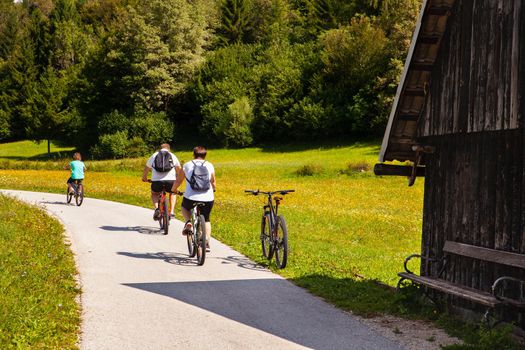 Family on cycle ride in countryside track in Bohinj, Slovenia