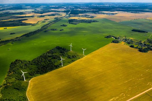 Windmills on the background of forests and fields. Windmill in nature.Belarus.