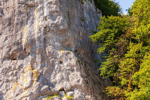 Rock climber ascending a challenging cliff in Bohinj, Slovenia