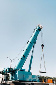 the stove is loaded onto a large blue car crane and prepared for operation . The largest truck crane for solving complex tasks