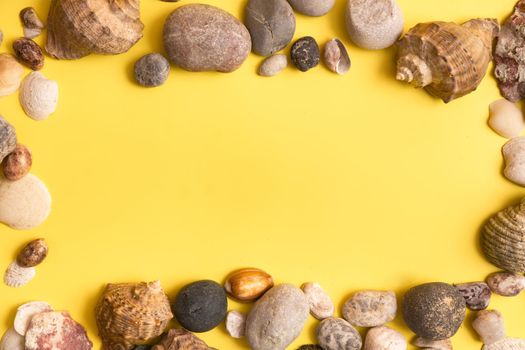 rocks and shells on a yellow background .Marine theme.