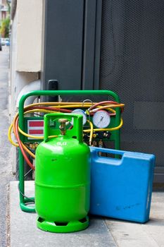 Green butane gas cylinder and blue tool case