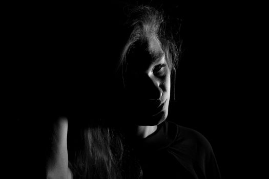 Black and white portrait of an Italian young woman on black background