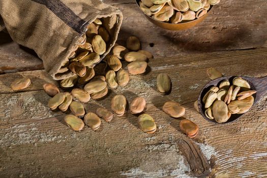 Top view of dried broad beans on wooden table