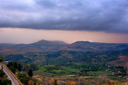View of Enna and Calascibetta skyline on cloudy sky in the summer season