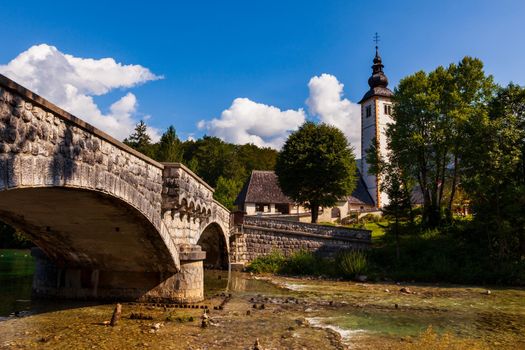 View of Bohinj lake with St John the Baptist church
and bridge, Slovenia